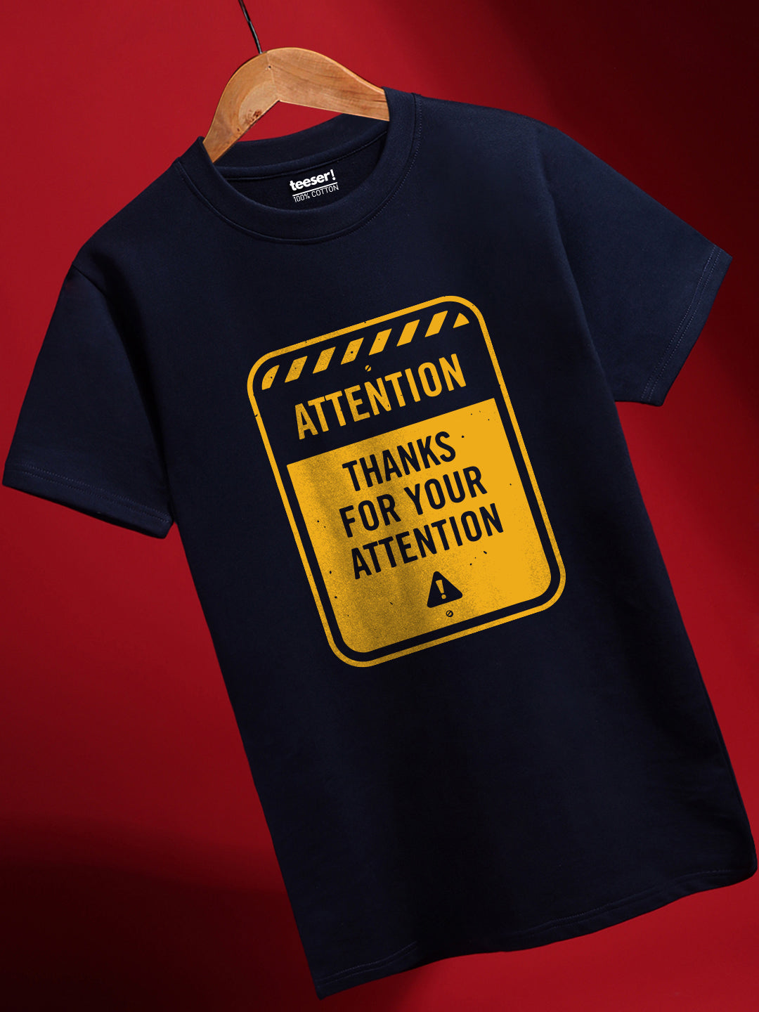 A navy blue cotton t-shirt with a graphic print of a road sign saying 'ATTENTION THANKS FOR YOUR ATTENTION'.