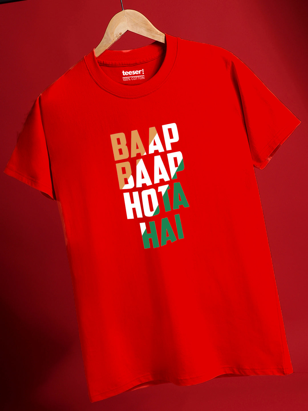 A red crew neck t-shirt with the text 'BAAP BAAP HOTA HAI' printed in a bold white and green font, displayed on a hanger against a red background.