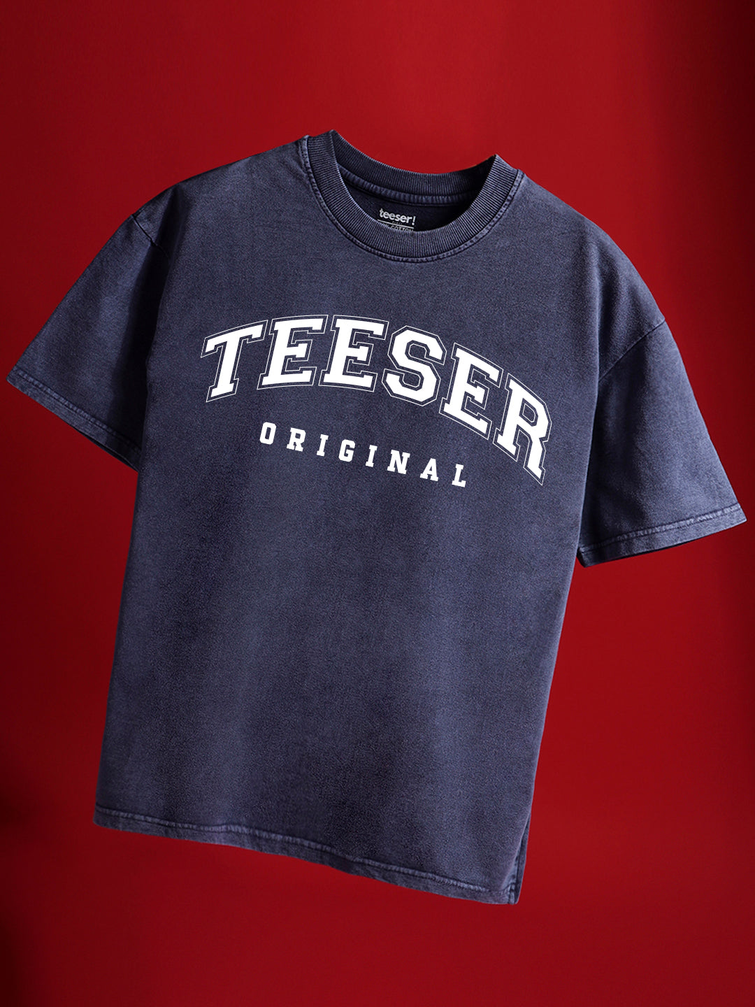 A navy blue crew neck t-shirt with the text 'TEESER ORIGINAL' printed on the front.