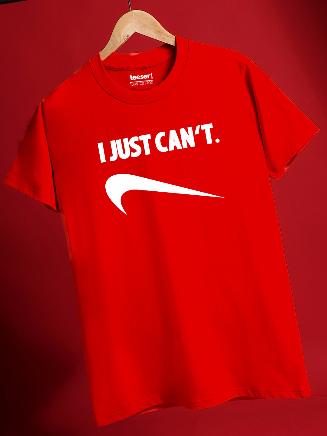 Red t-shirt with 'I JUST CAN'T.' text and Nike logo on a red background