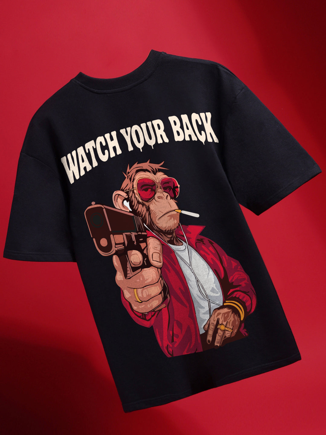Black t-shirt with a graphic of a monkey holding a gun and 'Watch Your Back' text on a red background
